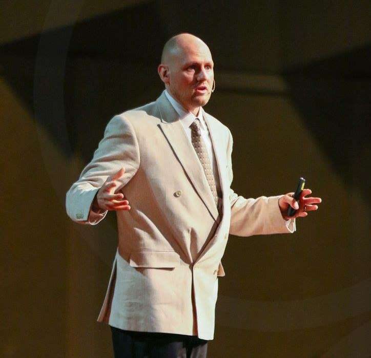 Israel Wayne speaking on stage
